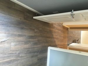 Luxury plank tile installed in a residential room by expert flooring contractors in Plantation, FL.