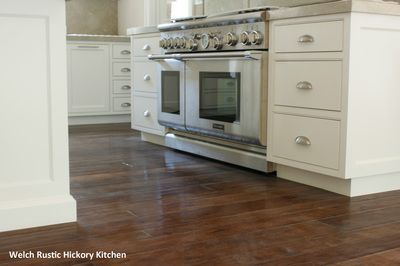 A kitchen with stainless steel appliances and white cabinets
