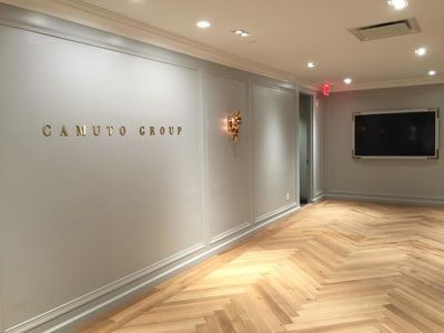 A hallway with a sign on the wall that says canuto group