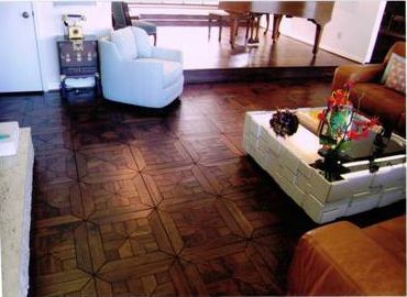 A living room with a wooden floor and a white coffee table