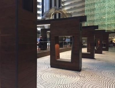 A row of wooden pillars in a lobby of a building.