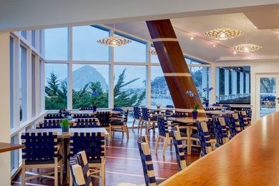 A restaurant with tables and chairs and a large window