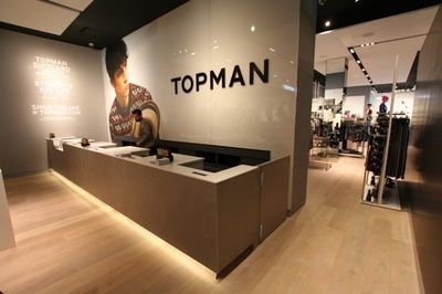 A topman store with a large sign on the wall