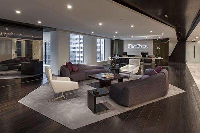 A living room with a couch , chairs , and a coffee table.