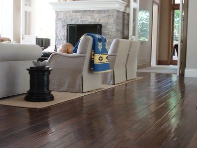 A living room with hardwood floors and a fireplace