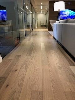 A living room with hardwood floors and a couch.