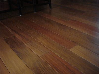 A close up of a wooden floor in a living room.