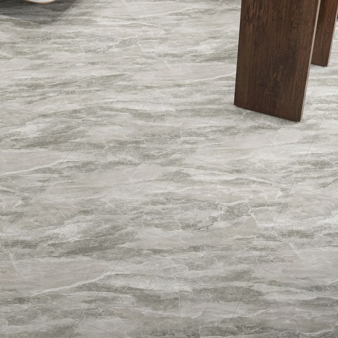 A man is laying a tile floor in a room.