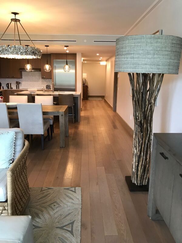 A long hallway leading to a kitchen and dining room