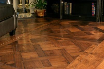 A living room with a wooden floor and a couch.