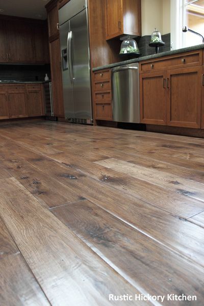 A kitchen with hardwood floors and stainless steel appliances