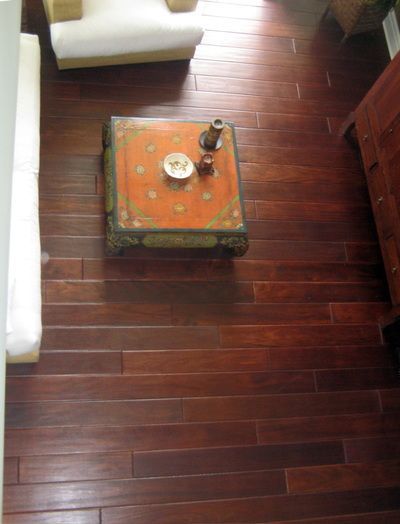 An aerial view of a living room with hardwood floors and a coffee table.