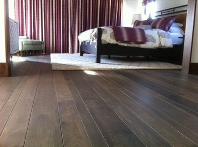 A bedroom with a large bed and purple curtains