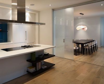 A kitchen with sliding glass doors leading to a dining room