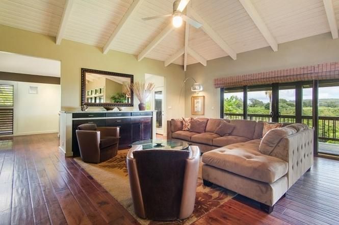 A living room with hardwood floors and a ceiling fan
