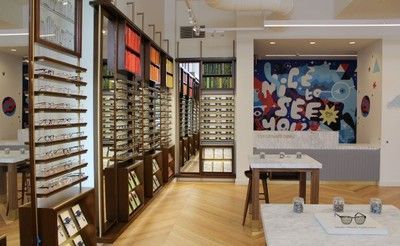 A store with a mural on the wall that says life to see more