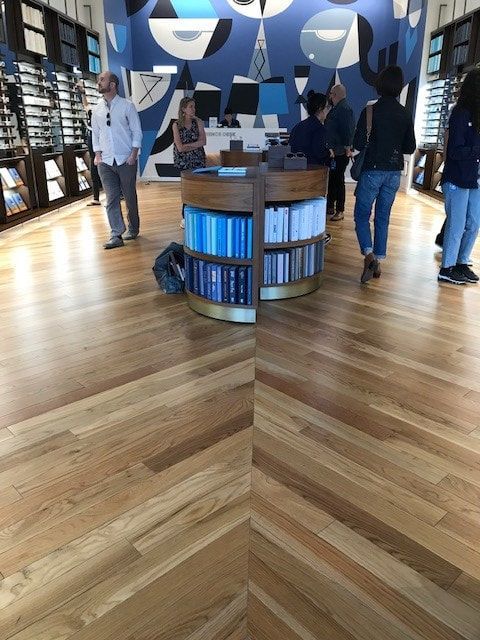A group of people are standing around a table in a store