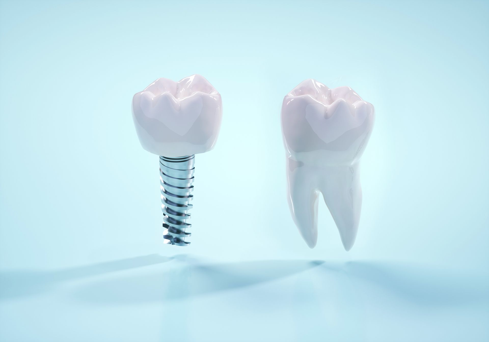 Un impianto dentale e un dente su uno sfondo blu.