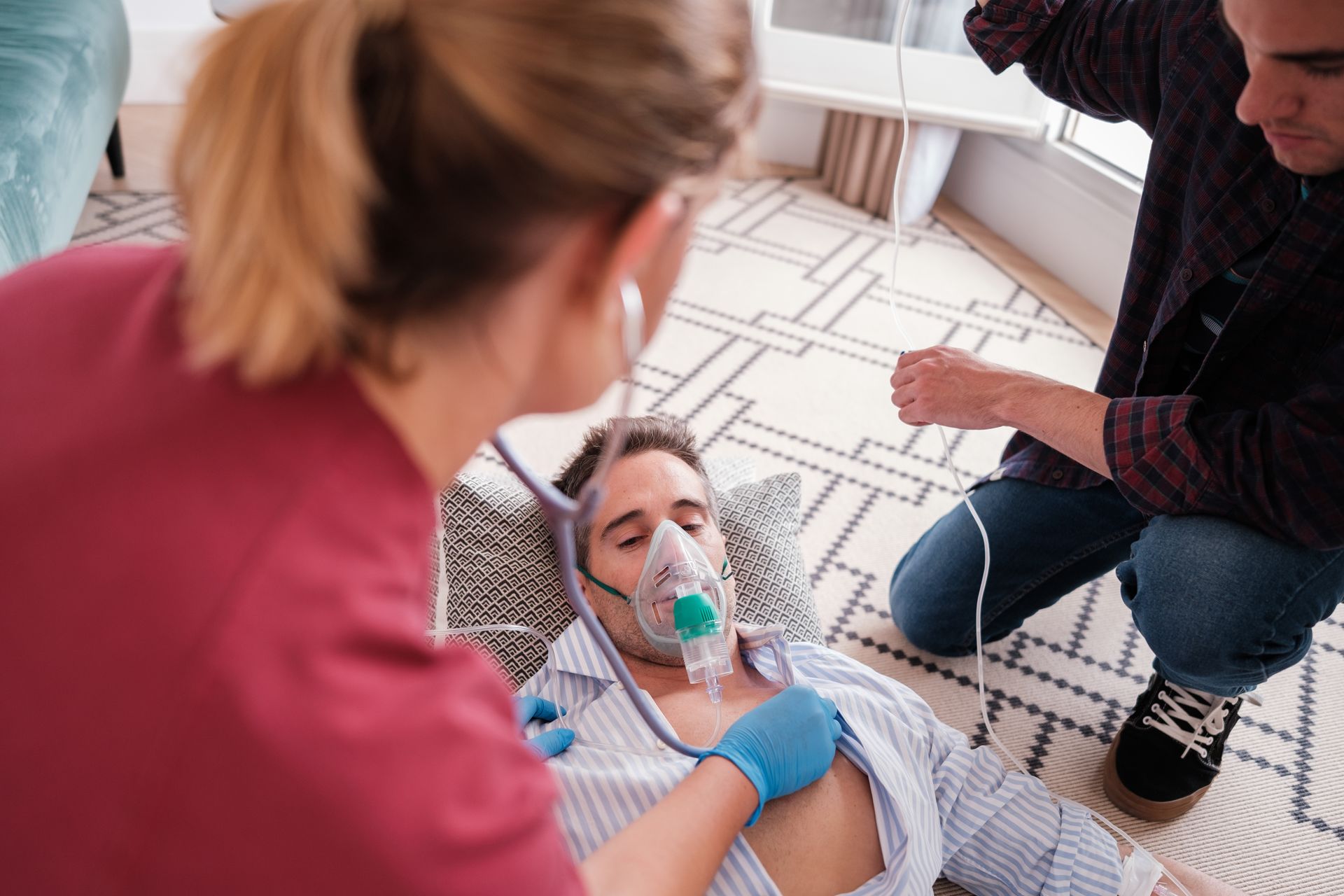Man on floor with oxygen mask.