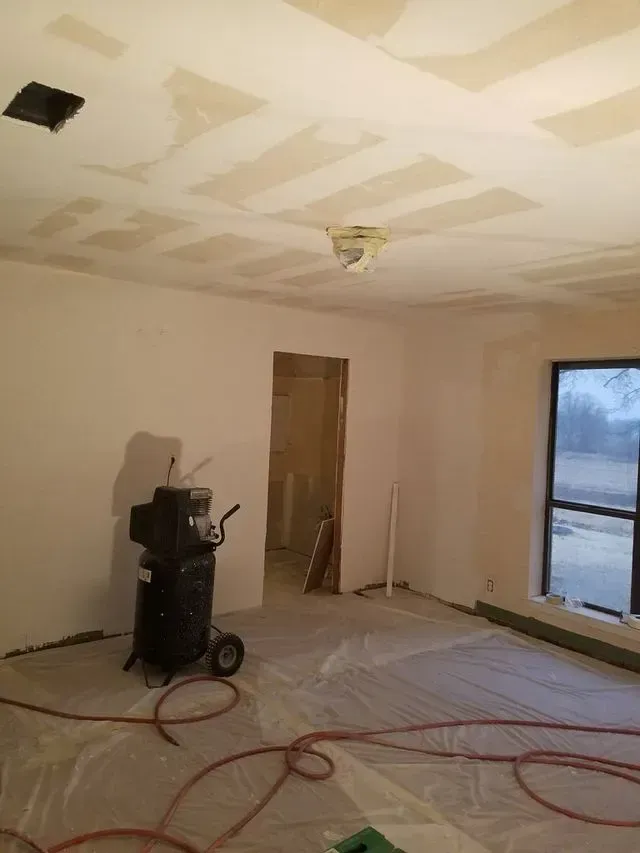 There is a vacuum cleaner in the middle of the room.