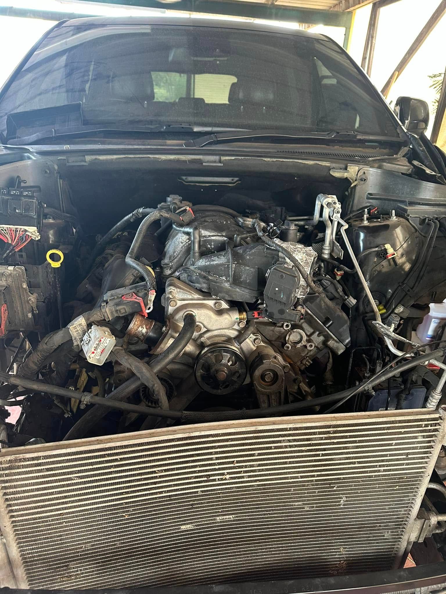 An Exposed Car Engine On A Garage