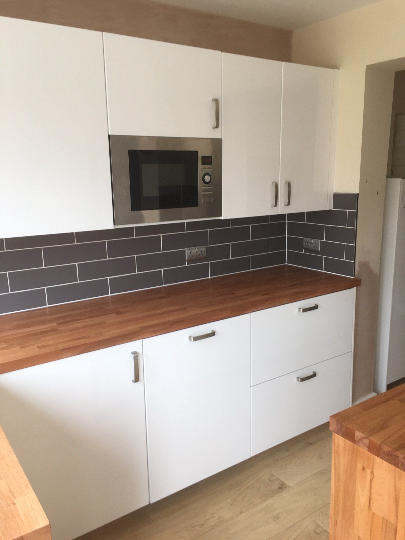 Dark grey kitchen tiles with worktop
