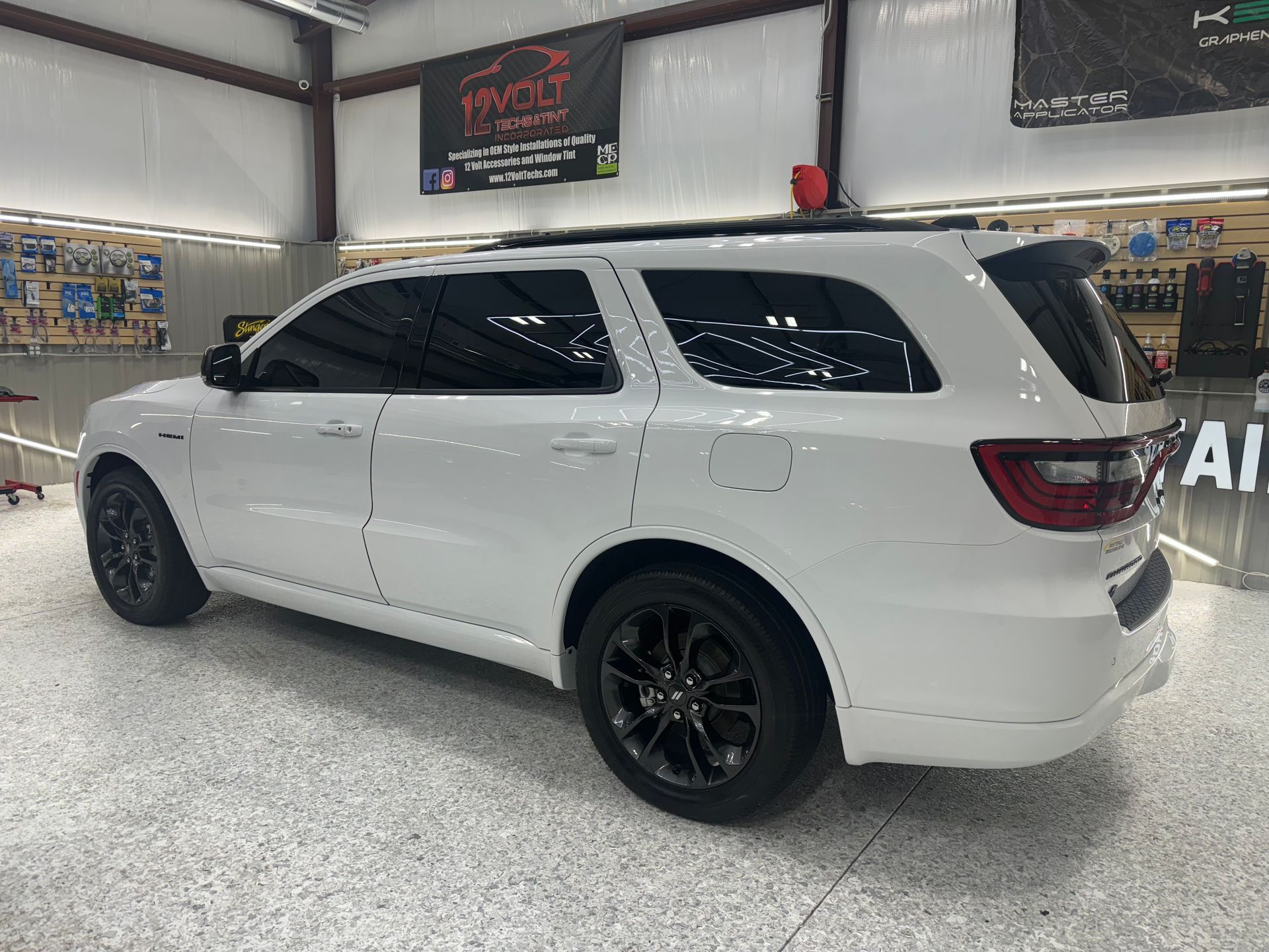 A white dodge durango is parked in a garage.