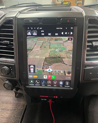 The dashboard of a ford f150 truck with a large screen.