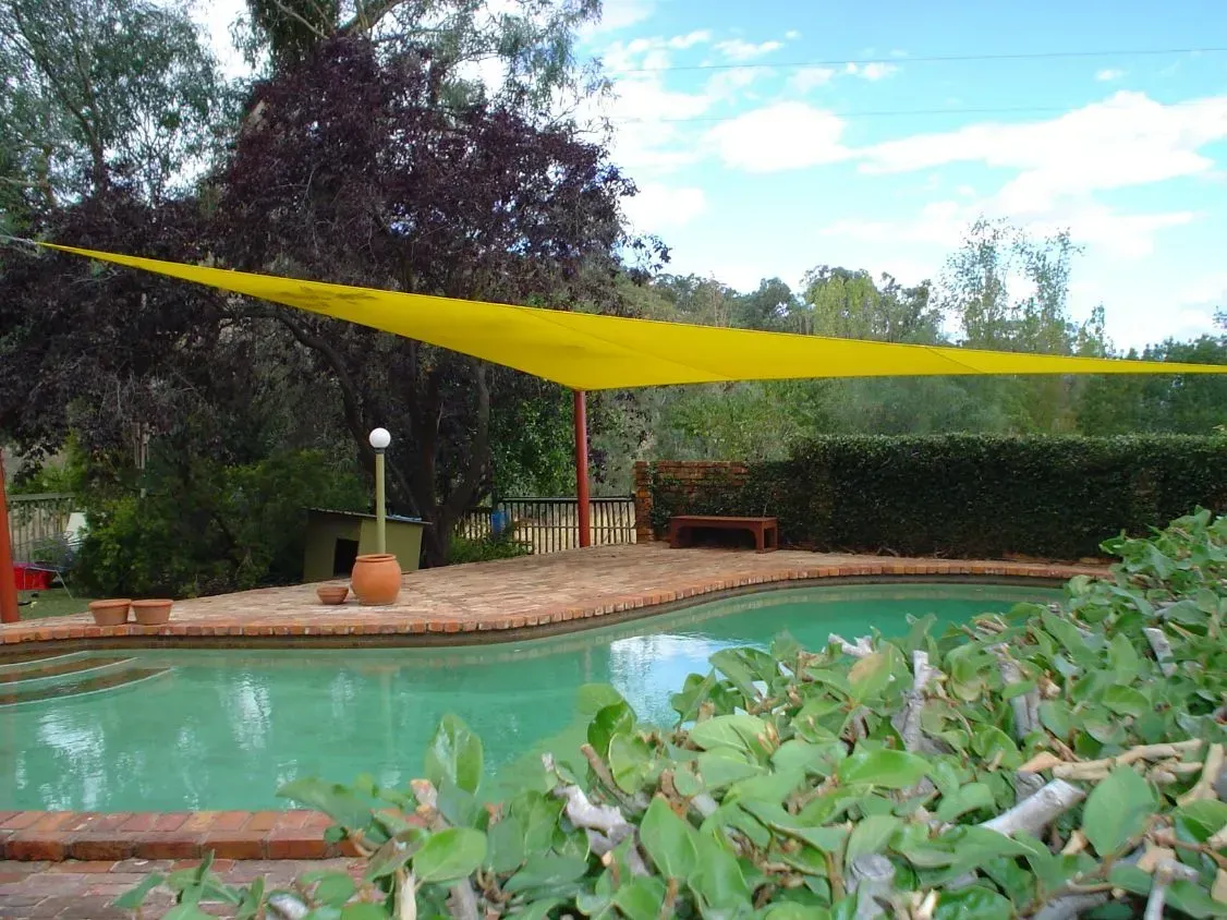 Yellow Shade Sail Over a Swimming Pool — The Gazebo and Shade Centre in Jindera, NSW