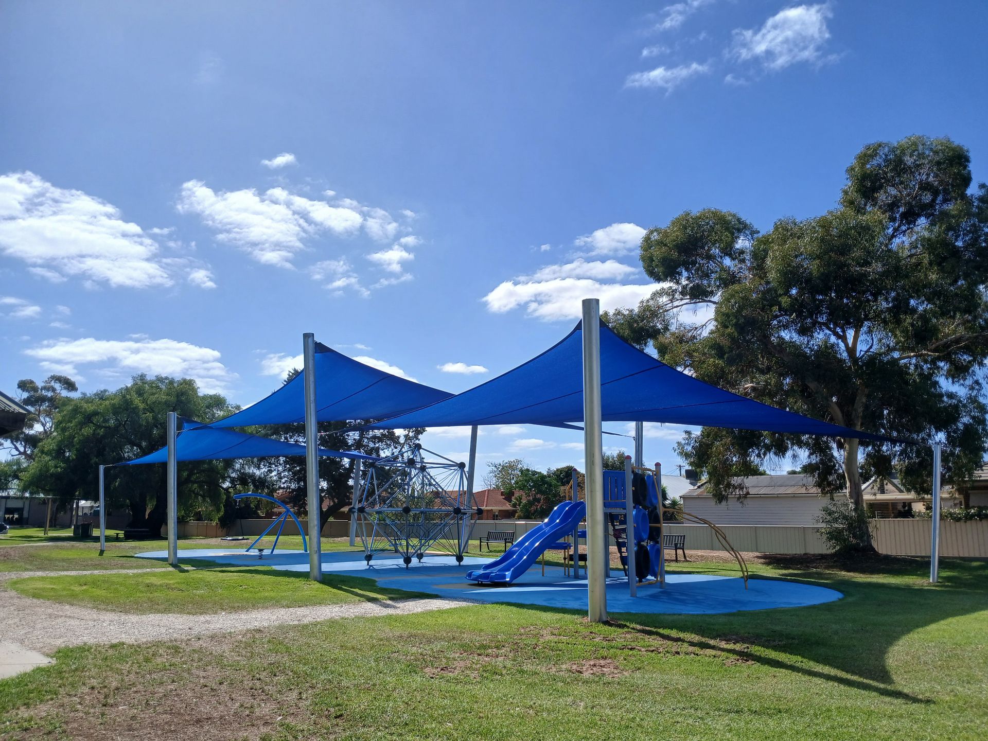Blue shade canopy over playground equipment in a park under a sunny sky — The Gazebo and Shade Centre in Yarrawonga, VIC