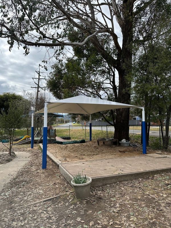 A Sandpit Under a White Shade Sail With Blue and White Posts — The Gazebo and Shade Centre in Jindera, NSW