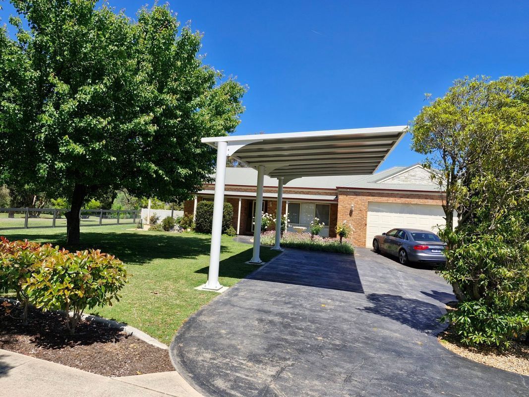 A House With a Large White Carport Over a Driveway — The Gazebo and Shade Centre in Jindera, NSW