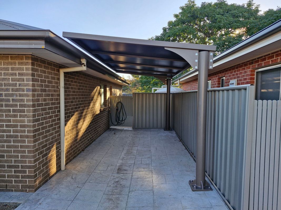 A Paved Outdoor Patio Area Featuring a Metal Cantilevered Roof Structure — The Gazebo and Shade Centre in Jindera, NSW