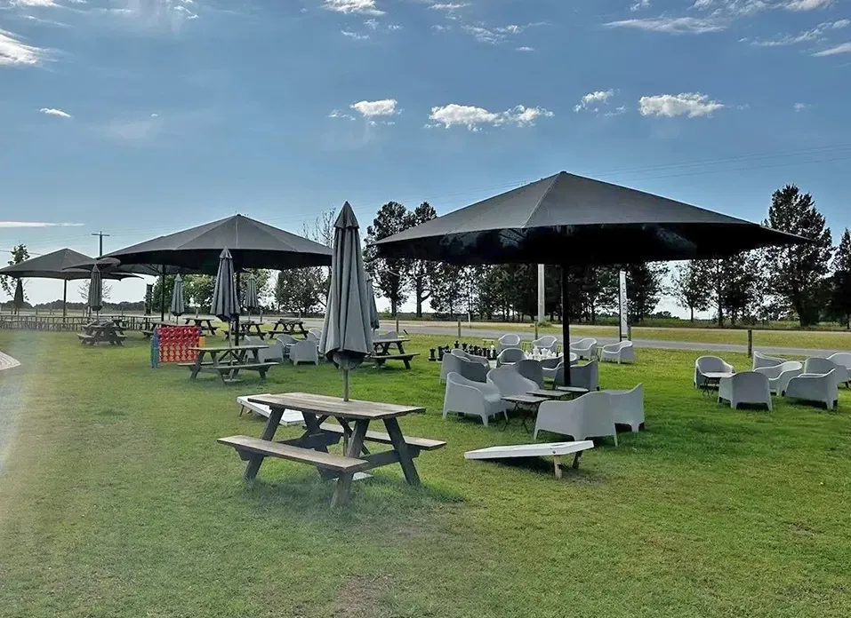Umbrellas Covering Tables and Chairs in A Picnic Area — The Gazebo and Shade Centre in Corowa, NSW