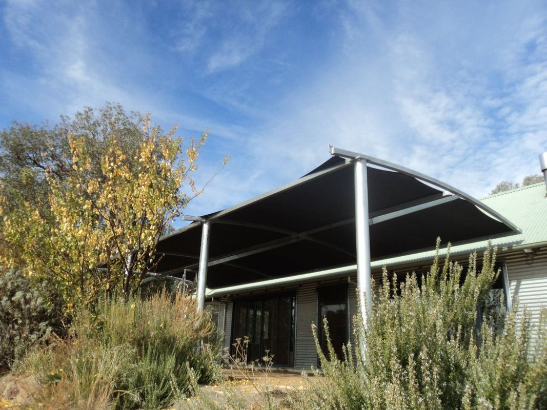 A Home With a Large, Black Awning Supported by Metal Posts — The Gazebo and Shade Centre in Jindera, NSW
