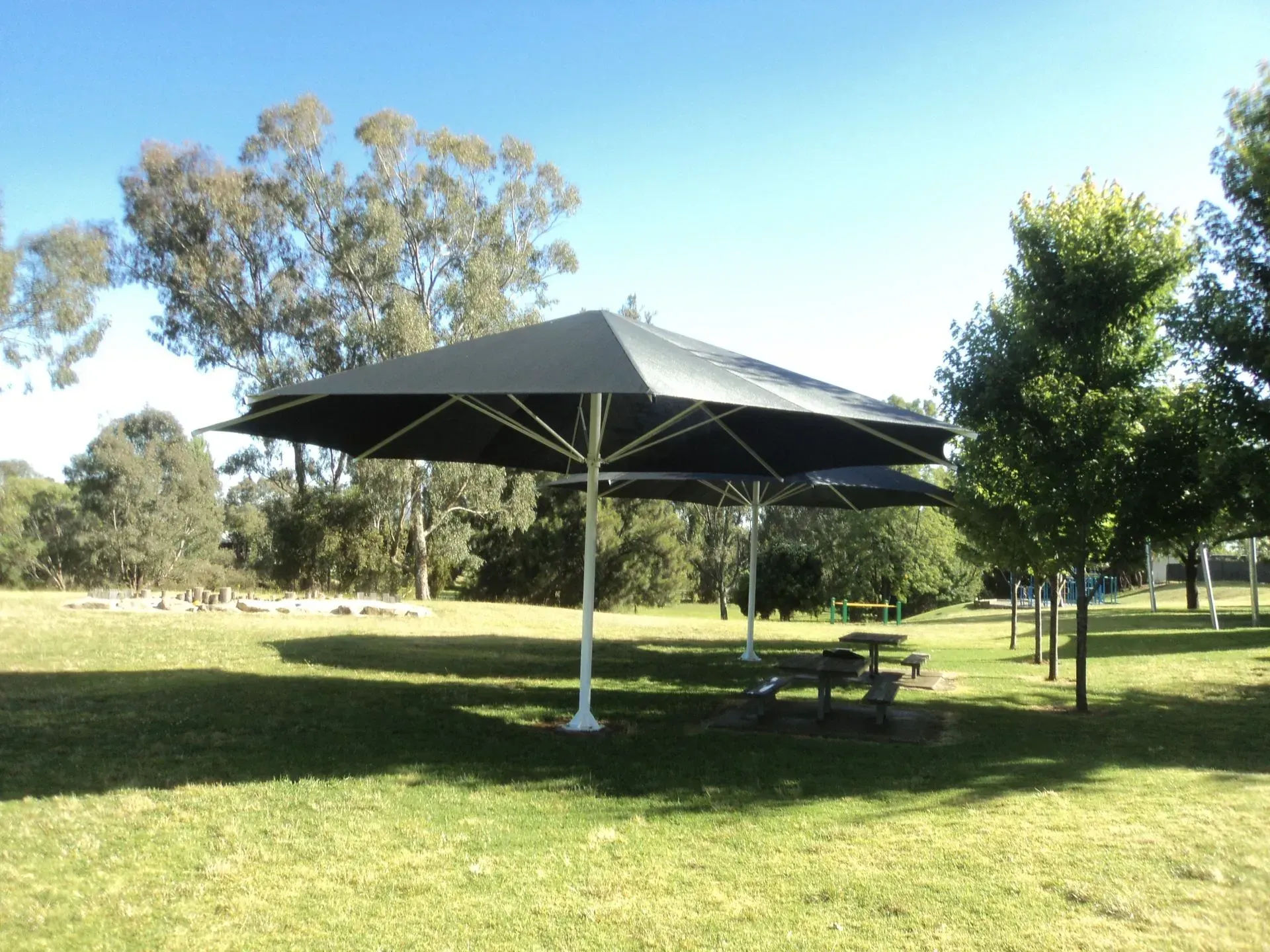 Picnic Area With Two Large Black Umbrellas — The Gazebo and Shade Centre in Jindera, NSW
