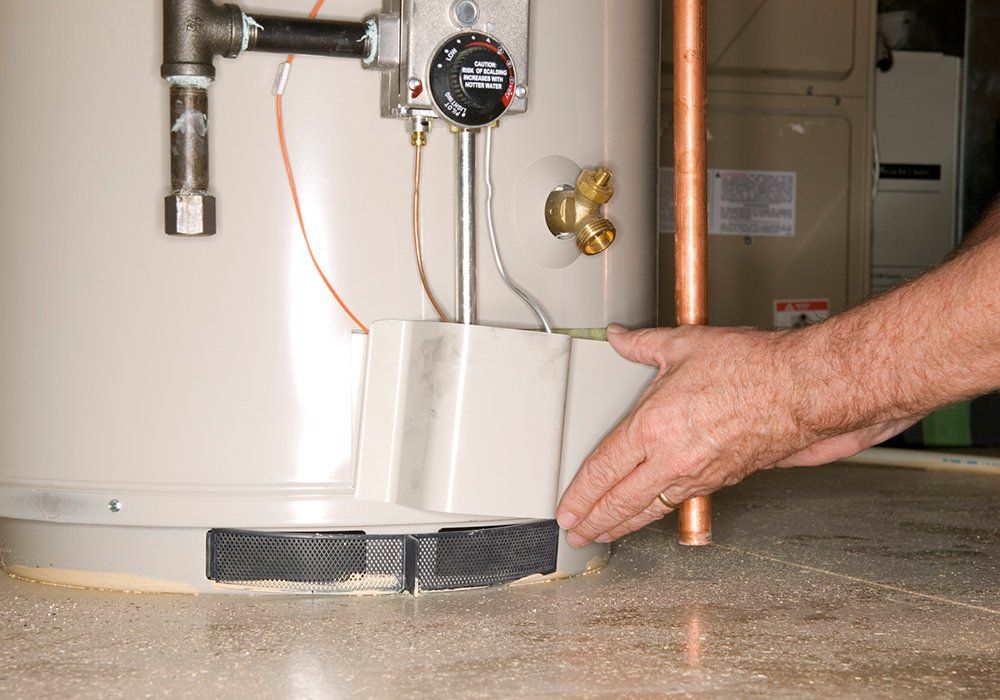 Man Checking Water Heater — El Paso, TX — Plumbers Drain Cleaning