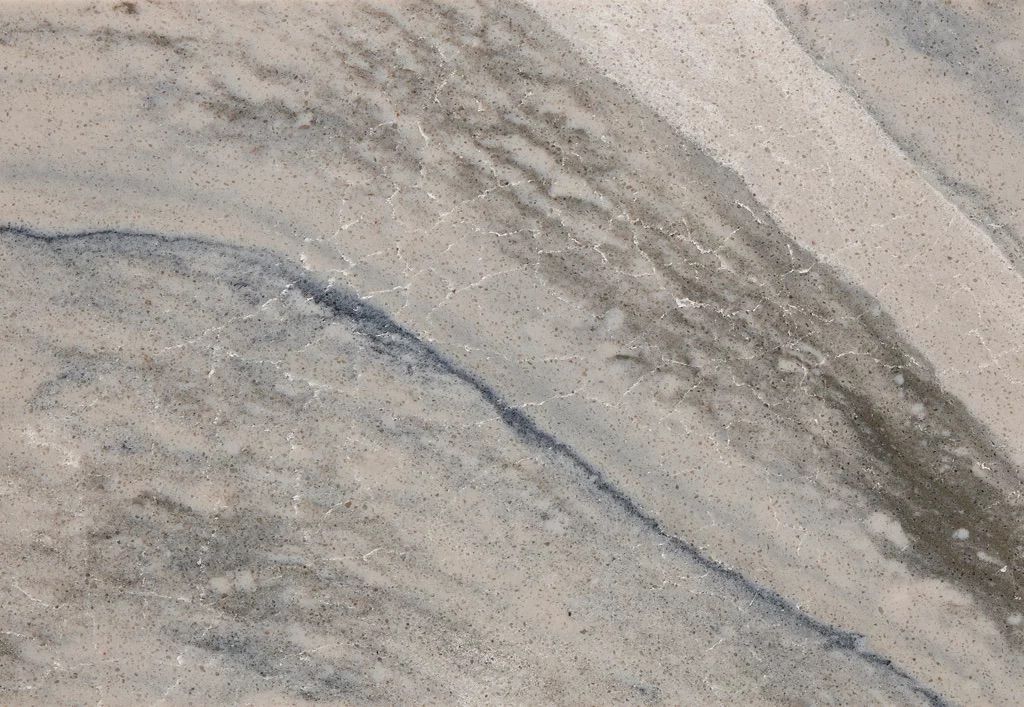 Close-up of marble with gray and blue streaks, and a white background.