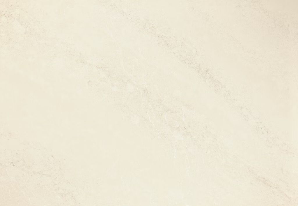 Cream-colored surface with subtle diagonal texture, reminiscent of stone or plaster.