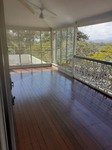 An Empty Room With A Wooden Floor And A View Of Trees — Dale Dow Floor Sanding In Kirwan, QLD