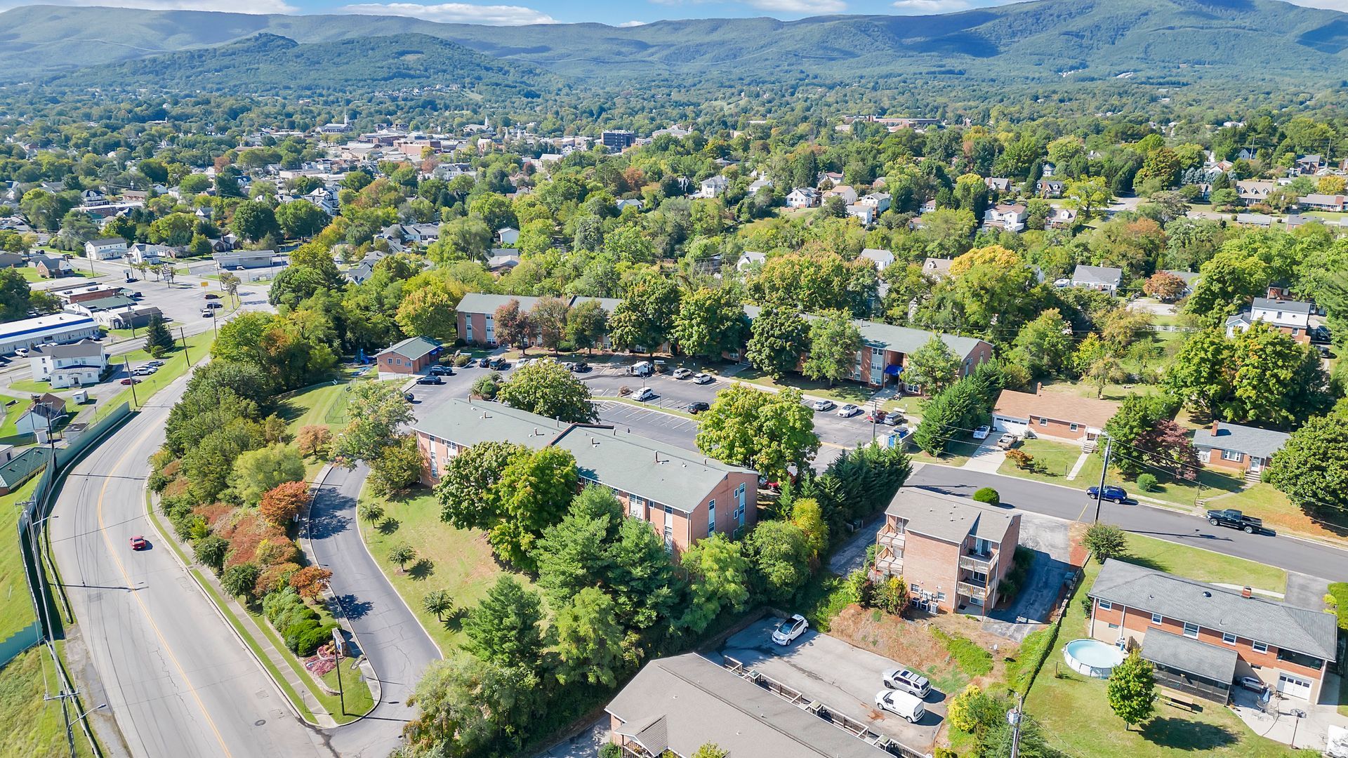 An aerial view of a residential area with mountains in the background.