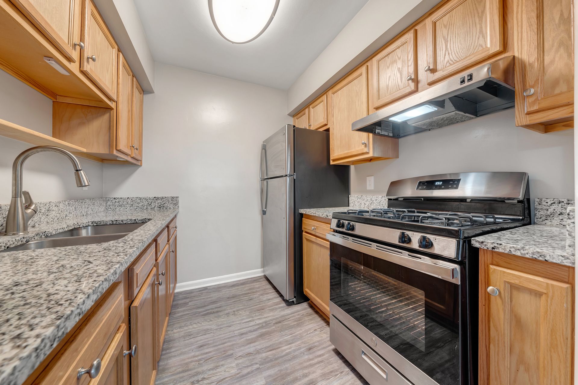 A kitchen with stainless steel appliances and granite counter tops.