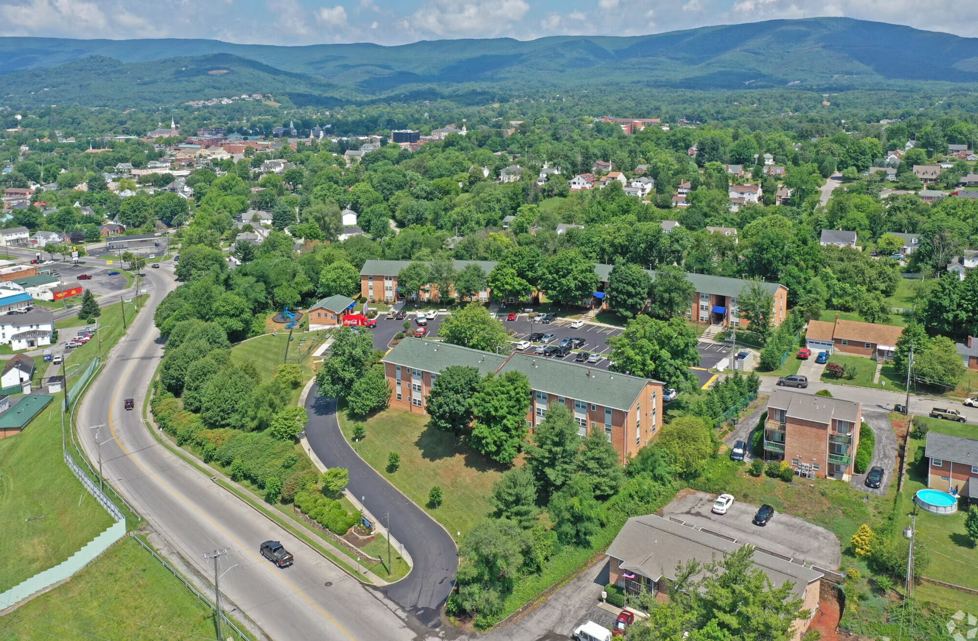 An aerial view of a small town with mountains in the background.