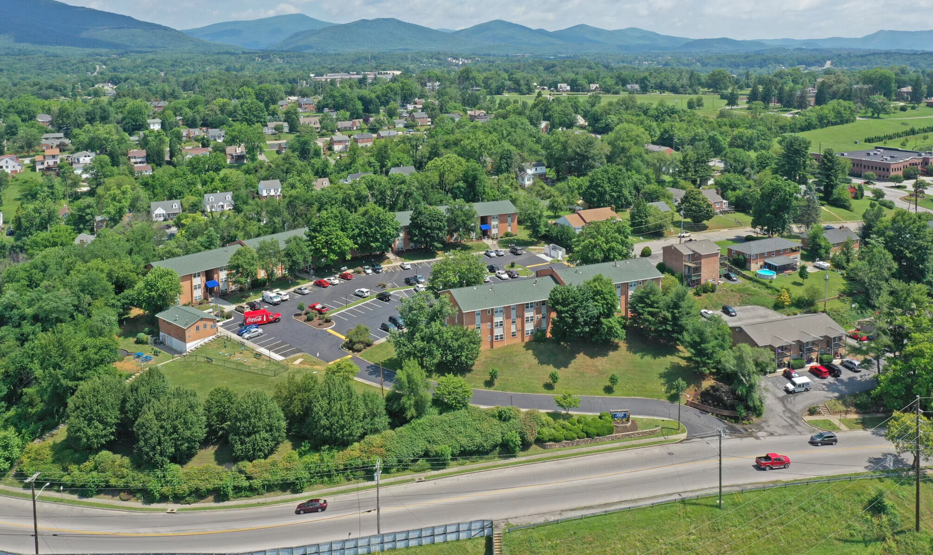 An aerial view of a small town with mountains in the background.