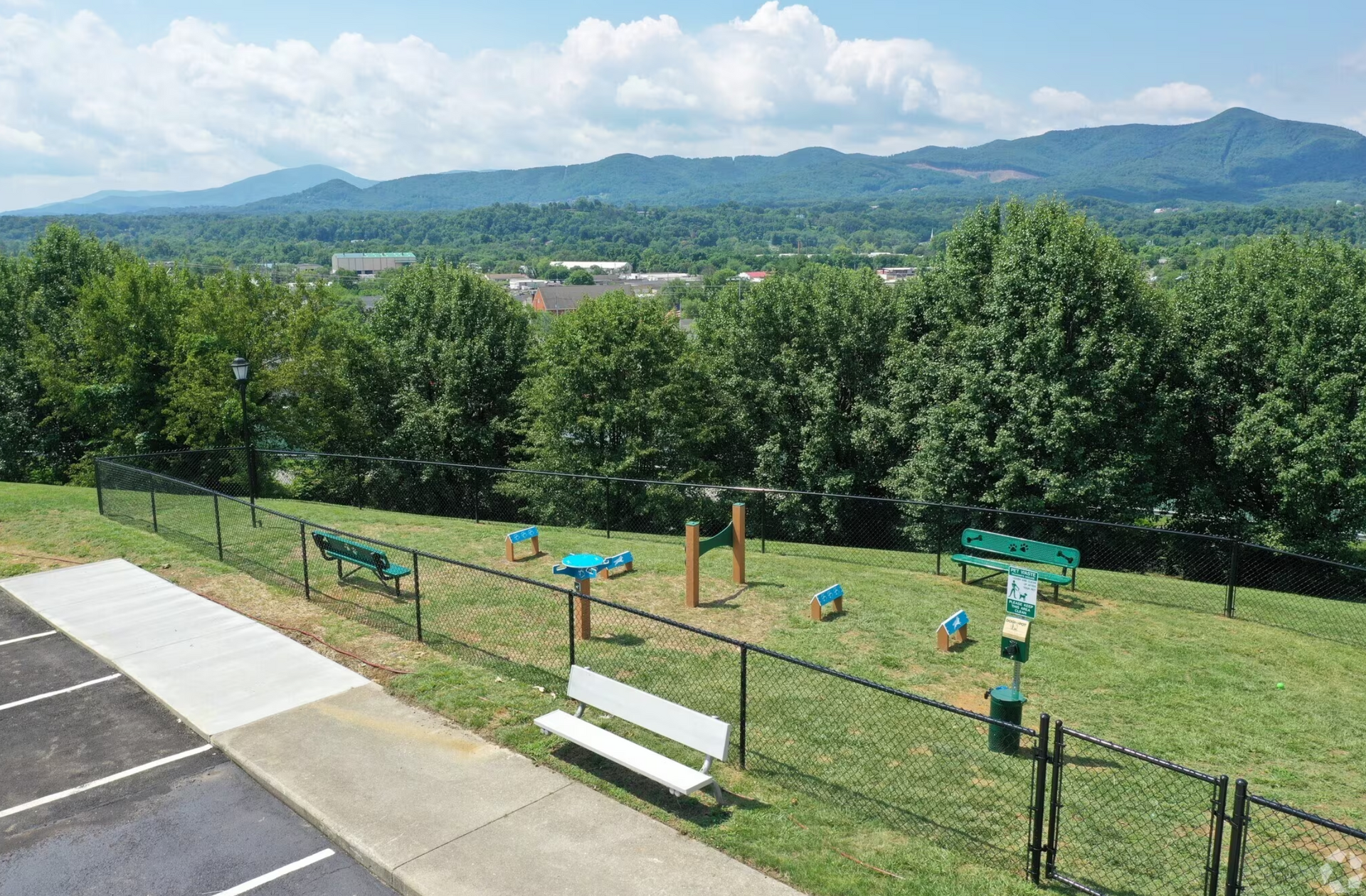 An aerial view of a dog park with mountains in the background.