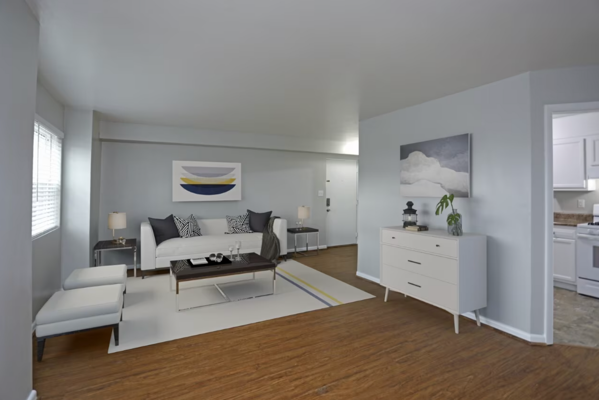 A living room with a couch , coffee table , and dresser.