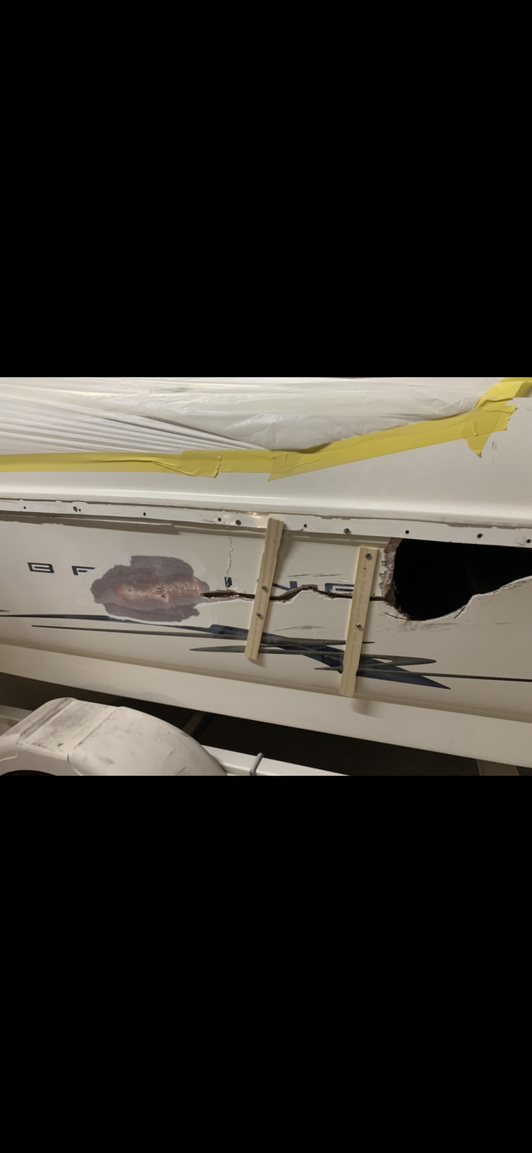 A close up of a boat with a hole in it.