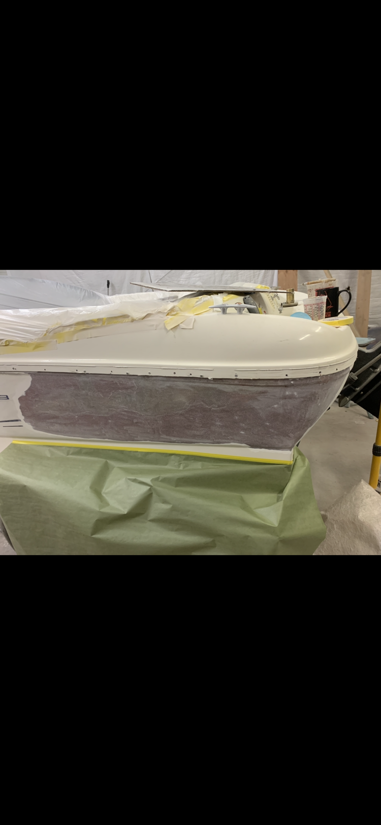 A bathtub is being painted in a workshop.