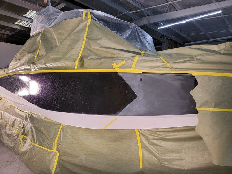 A boat is covered in plastic and yellow tape