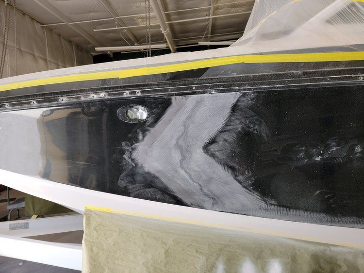 A black and white boat with a yellow stripe on the side